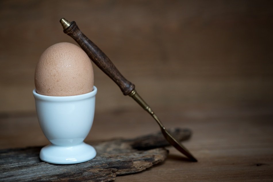 egg cup with brown egg and spoon