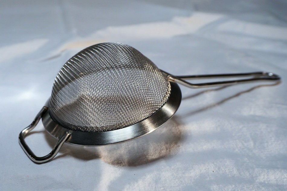 silver sieve on a white table