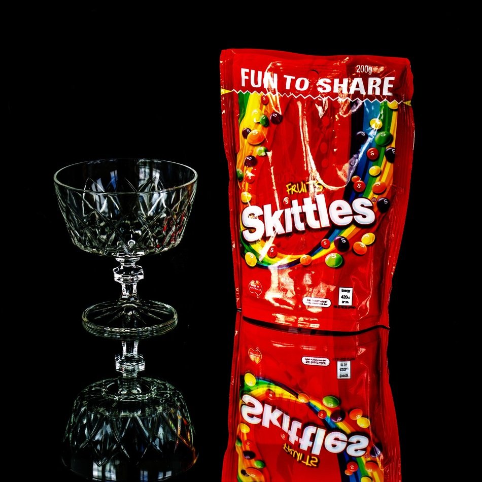 skittles near the glass cup