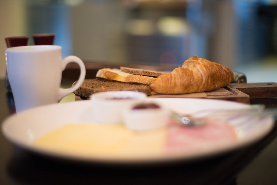 closeup picture of Breakfast of Croissant and Coffee on Table