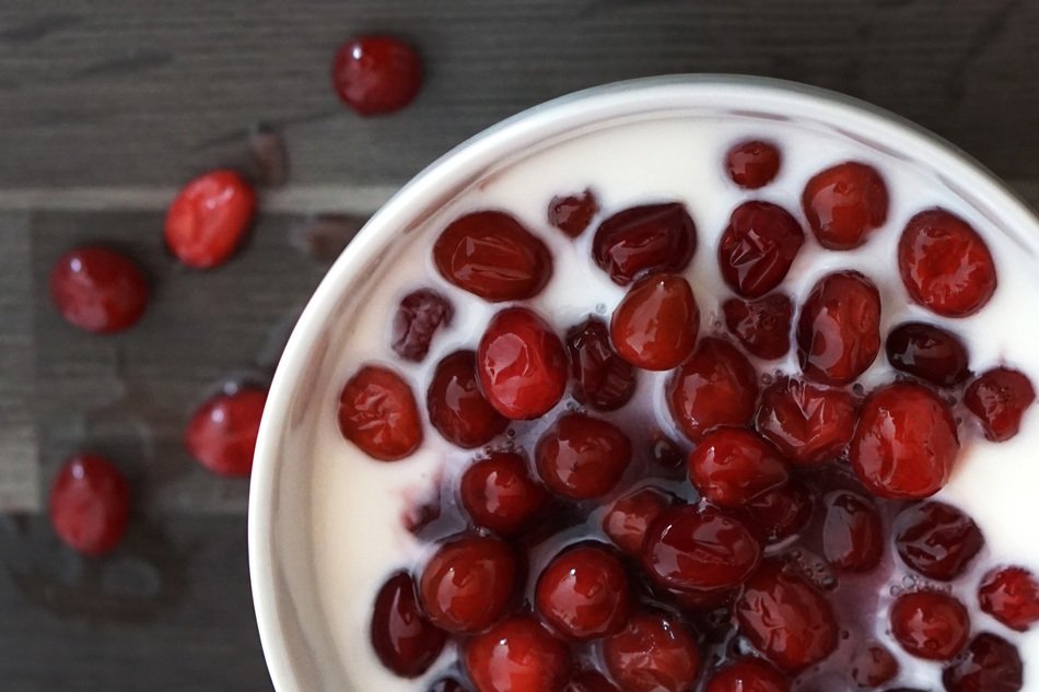 Cranberry with Yogurt in cup on table