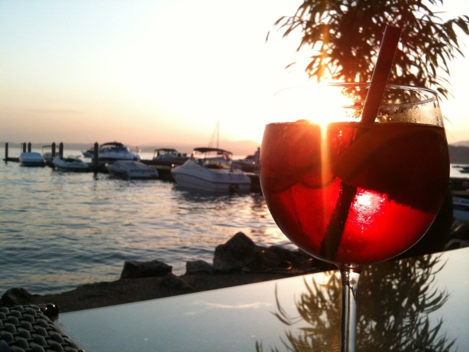 red cocktail on a table in a cafe on the shores of Lake Garda