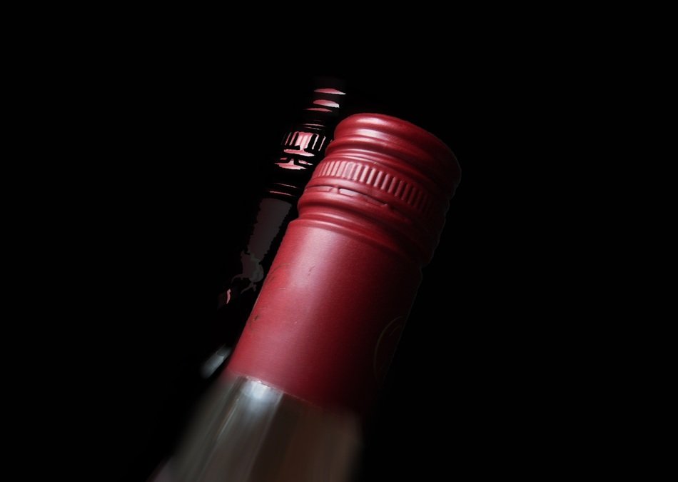 bottleneck of red wine on black