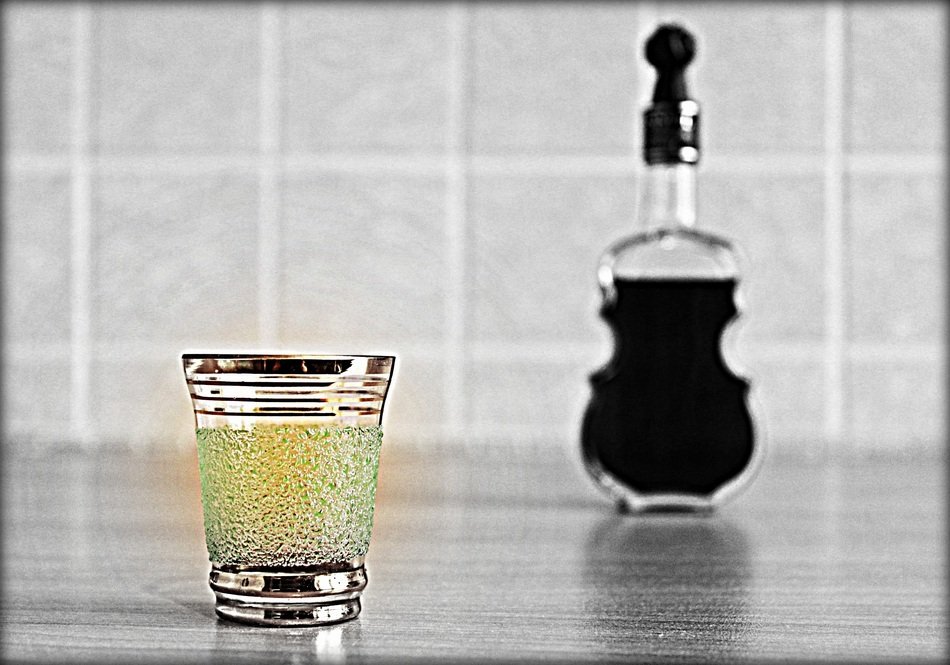 glass and bottle in the shape of a violin