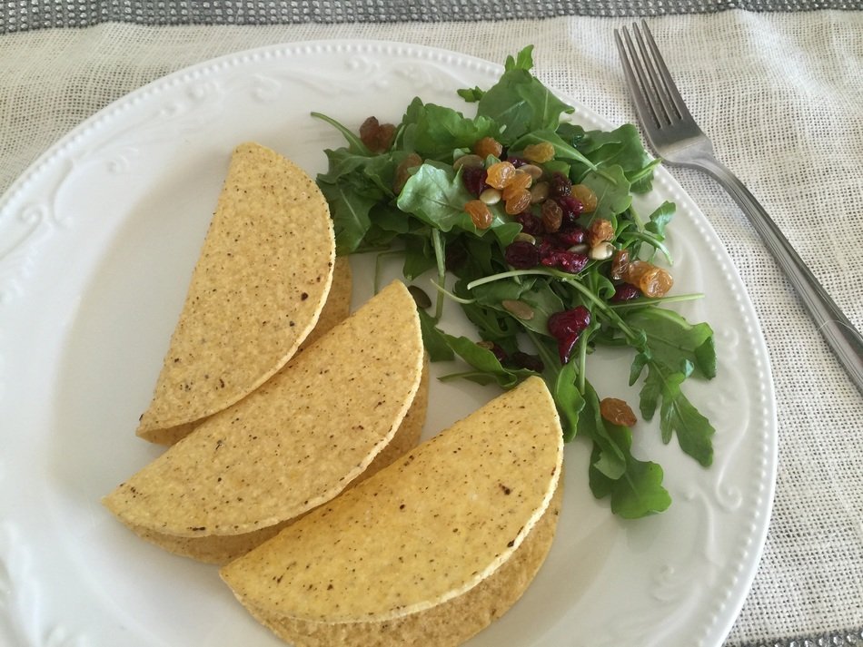 crispy tacos and vegetables are on a plate