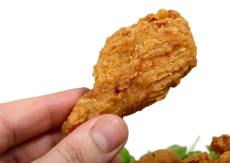 delicious chicken leg in hand