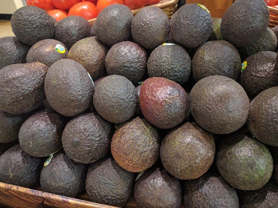 Black avocados in the market