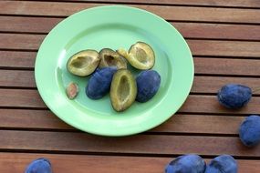 peeled plum on a green plate