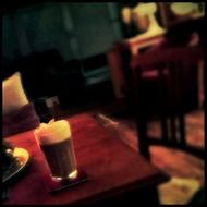 blurred picture of coffee on a wooden table in a cafe