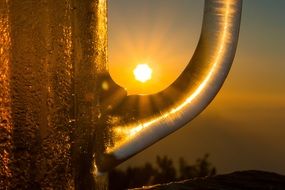 the sun is in the handle of a mug of beer