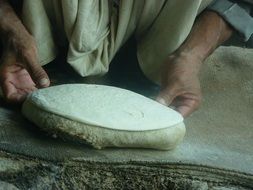 Man is making bread from the dough