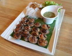 delicious shellfish with sauce on a white plate