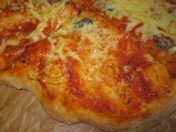 pizza with cheese and tomato sauce on the table