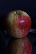 apple on the table in the dark