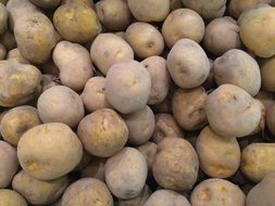 a pile of potatoes in a supermarket