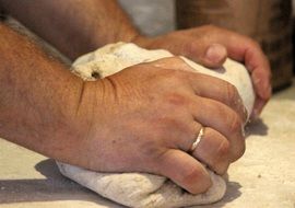 dough in the hands of a cook