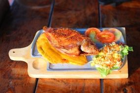 fried crappie on a wooden board