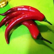 four bright red chili peppers