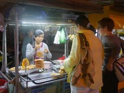 people near the street cafe counter