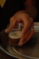 Man holds tea glass in hands