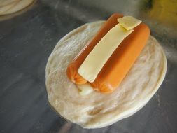 sausages and cheese on bread cake