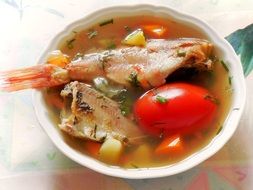 fish soup in a white plate