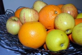 Fresh Fruits, Apples and Oranges in bowl close-up