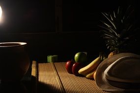 fruits on a table in a dark kitchen