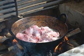 cook meat in a cauldron at the stake