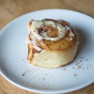 sweet cinnamon roll is on the plate