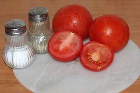 cut in half tomato with salt and pepper