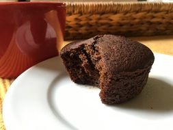 bitten chocolate cupcake on a plate