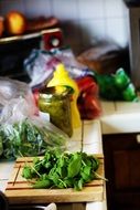 green basil on a cutting board in the kitchen