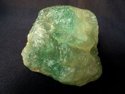 stone fluorite on a dark surface