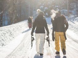 people walk on a snowy road