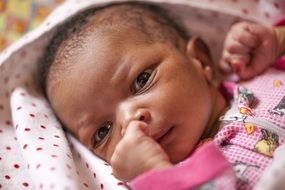 little black baby in diaper