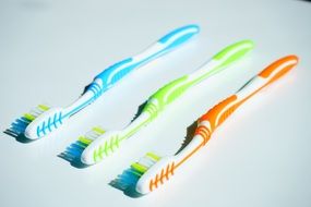 three bright toothbrushes