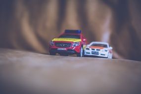 two toy cars in a children's room