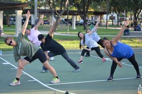 womens yoga on the sports ground