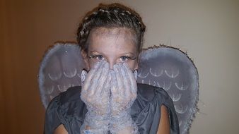 Portrait of girl dressed up in crying Angel