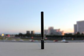 black electronic cigarette on city background