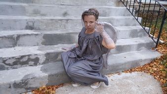 woman in grey costume of an angel