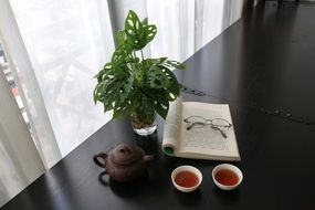 two tee cups and book