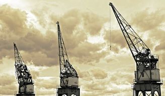 harbour cranes on the cloudy sky