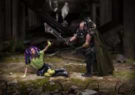 fantasy dressed man with axe above girl sitting on ground