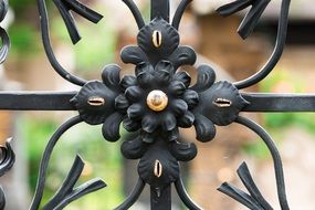 Gilded Wrought Iron flower on fence