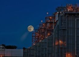 Full Moon in deep blue sky above Power Plant