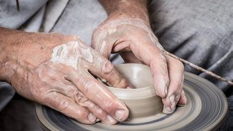 hands make a vessel of clay