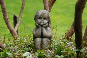 brass statue of a child in the park