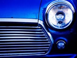 а headlight on a blue car